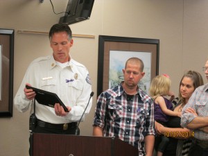 Fire Chief Bob Stewart presenting Mike and Chelsey with their award at the Yakima City Council Meeting.