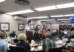 Brian Smillie and his family at the podium with Chief Bob Stewart during the Yakima City Council Meeting.